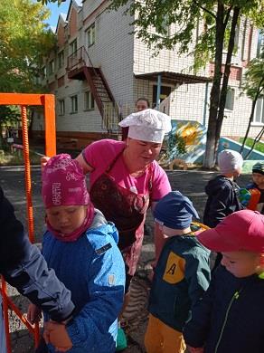 Повар помогает младшей группе